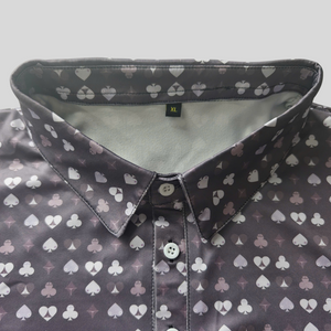 Close-up of a shirt with card suit pattern on a gray background