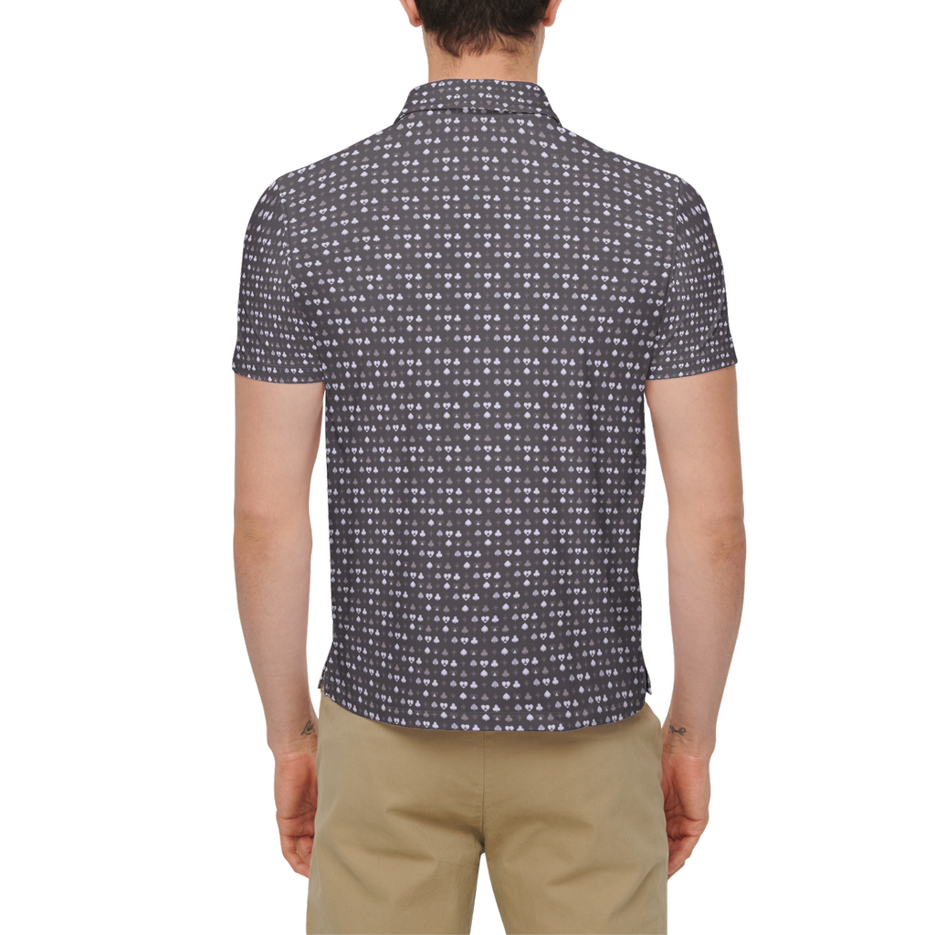 Person wearing a patterned shirt and beige pants on a white background